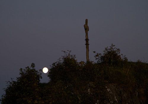 Stone cross and full moon
